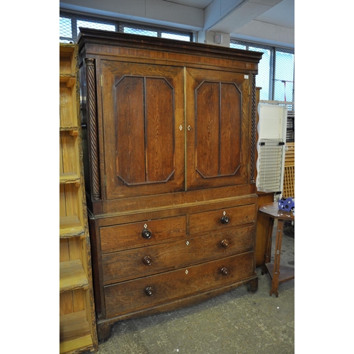 539 - Early 19th Century oak two stage press cupboard having moulded cornice, the interior with two fitted... 