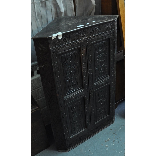 578 - Heavily carved and stained hanging blind panelled corner cupboard.
(B.P. 21% + VAT)