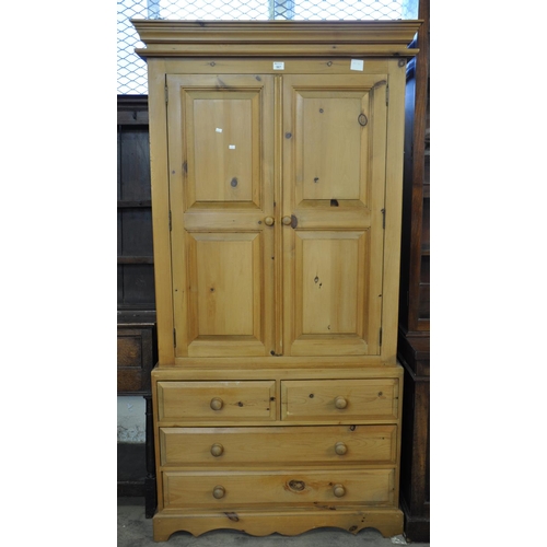 567 - Modern good quality pine two door wardrobe above a base of two short and two long drawers. 
(B.P. 21... 