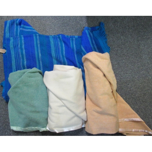 104 - Four vintage blankets to include; a blue striped bed cover by spectrum, three woollen blankets in va... 