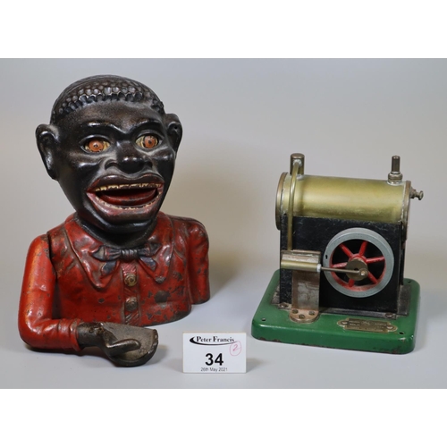 34 - Cast iron black man money box, together with a tin plate 'Model Junior' steam engine. (2)
(B.P. 21% ... 