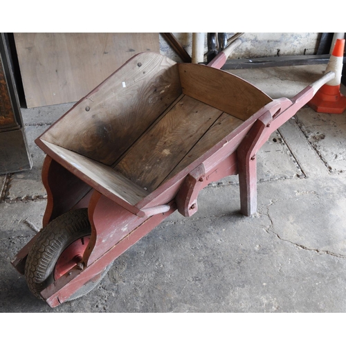 585 - Painted wooden wheelbarrow.
(B.P. 21% + VAT)