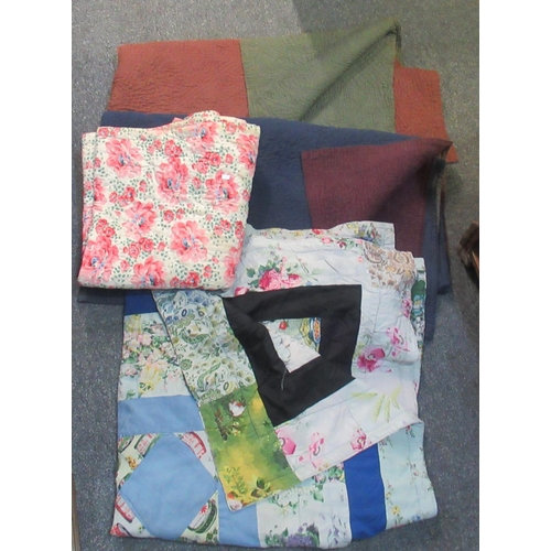 100 - Four vintage quilts; two plain with different colours to the other side, a floral design and a patch... 