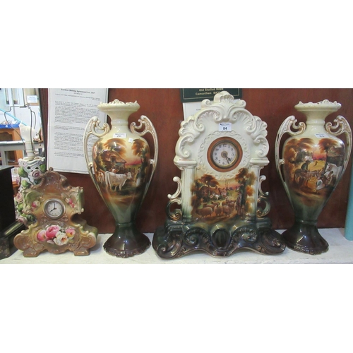 84 - Early 20th Century Staffordshire pottery clock garniture set comprising; large mantel clock and a pa... 