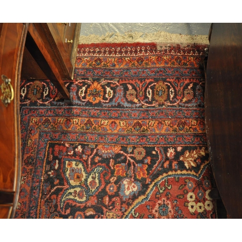 481 - Large Middle Eastern red ground carpet overall foliate decorated around central medallion with multi... 