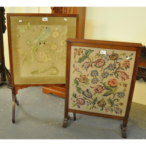494 - Two early 20th Century glazed firescreens, one with needlework decoration depicting a bird amongst f... 