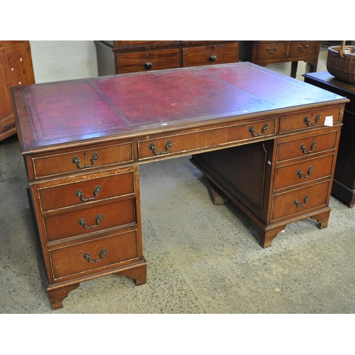 515 - Early 20th Century mahogany knee hole desk with leather inset top and a bank of three drawers to eac... 