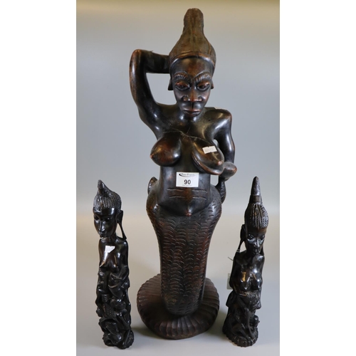 90 - Carved African tribal fertility and mythical figurine, together with a pair of carved tribal fertili... 