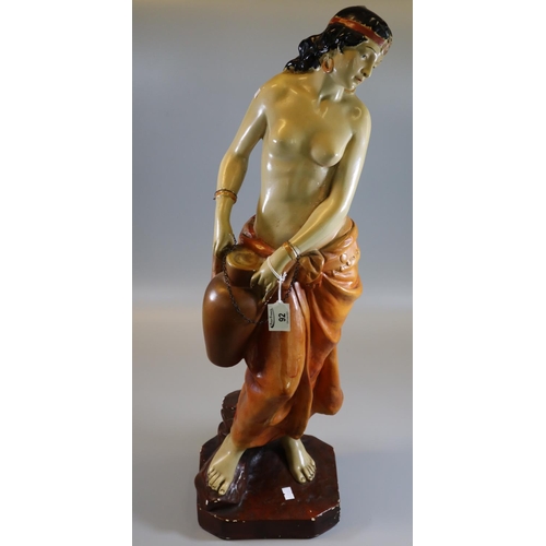 92 - Early 20th Century pottery semi-nude figurine of a water carrier. 
(B.P. 21% + VAT)