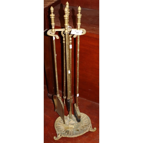 97 - Brass companion stand with tongs, poker, shovel etc. 
(B.P. 21% + VAT)