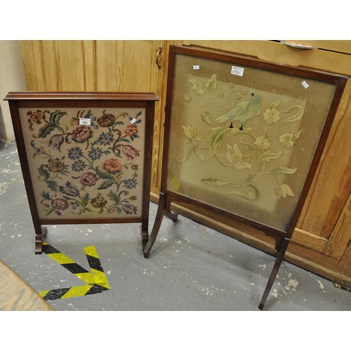 552 - Two early 20th Century glazed firescreens, one with needlework decoration depicting a bird amongst f... 