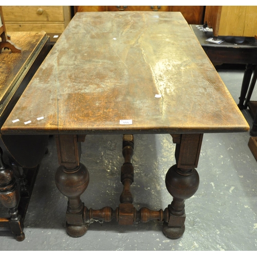 555 - Early 20th Century oak dining table having carved baluster supports standing on pad feet with turned... 