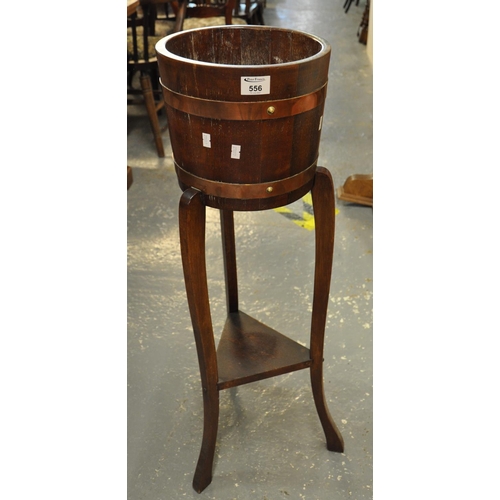 556 - Early 20th Century oak and copper banded coopered barrel on stand with under tier. 
(B.P. 21% + VAT)