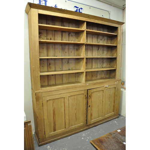 557 - Late 19th/early 20th Century pine two stage kitchen dresser or bookcase, the moulded cornice above t... 