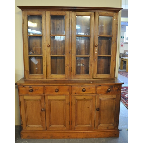 562 - Pine two stage cabinet back dresser, the moulded cornice above four glazed doors, the projecting mou... 