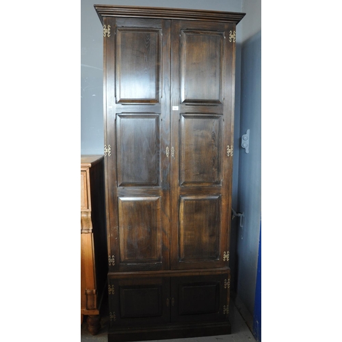 566 - Reproduction oak two door blind panelled hall cupboard.
(B.P. 21% + VAT)