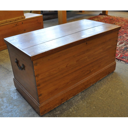 576 - Vintage pine trunk with hinged lid, the interior revealing fitted candle box with cast metal handles... 