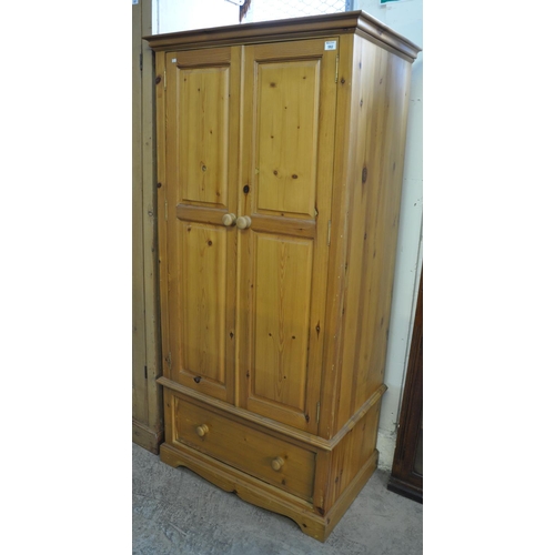 582 - Modern pine two door wardrobe with under drawer. 
(B.P. 21% + VAT)