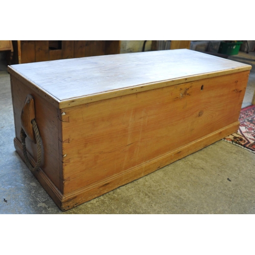 585 - Vintage pine trunk with hinged lid, the interior revealing fitted candle box and having rope handles... 