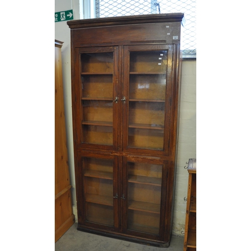 586 - Early 20th Century stained four door glazed cabinet of narrow proportions, 104 x 21 x 205cm approx. ... 