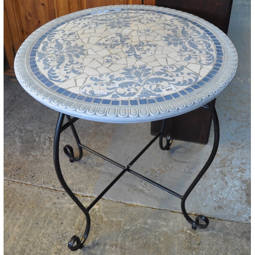 603 - Modern florally decorated tile top circular conservatory or garden table on metal tubular base. 
(B.... 