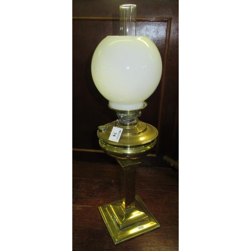 74 - Early 20th century single oil burner with globular opaline glass shade above a brass reservoir and s... 