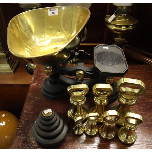 75 - Vintage cast iron shop scales with brass pan and assorted graduated weights of circular and bell-sha... 