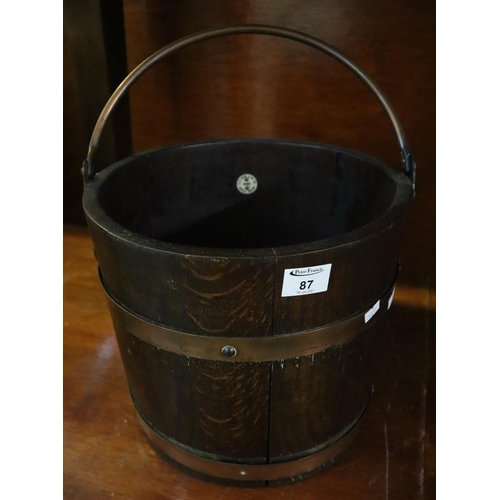 87 - R.A. Lister & co. Ltd. Dursley oak and copper banded coopered barrel with copper swing handle.
(B.P.... 