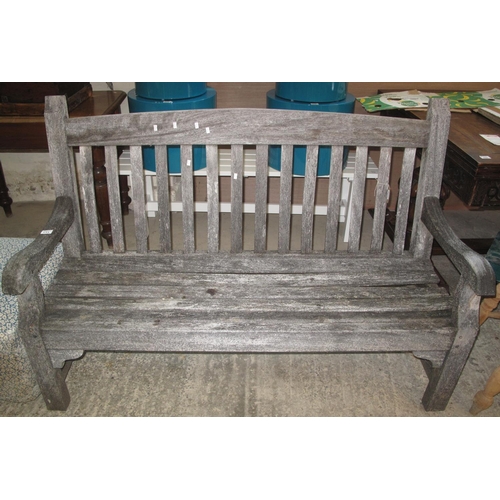 593 - Weathered probably teak set of garden furniture to include; two elbow chairs, open arm bench and tab... 