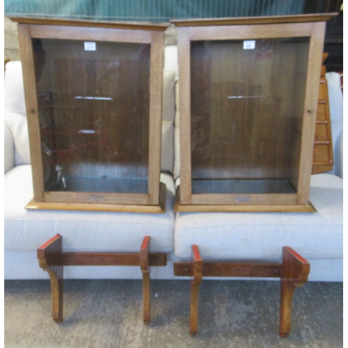 607 - A pair of oak ecclesiastical wall display units, with single glazed door, glass shelves to the inter... 