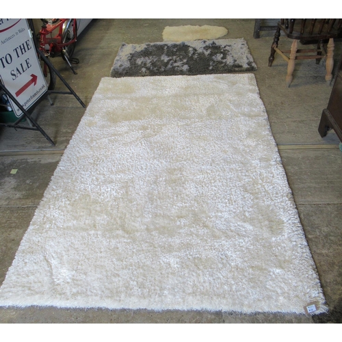 610 - Modern ivory ground 'Indulgence' rug.150 x 240cm approx. Together with a Tungsten silvered shag pile... 