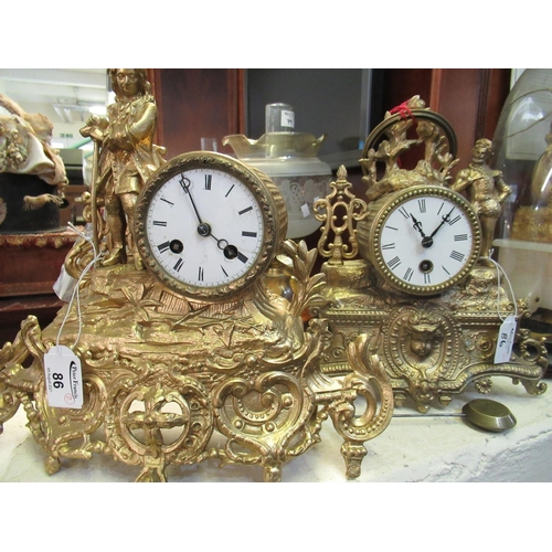 86 - Two similar French gilt spelter drum head shaped mantel clocks, both figure mounted and with scroll ... 