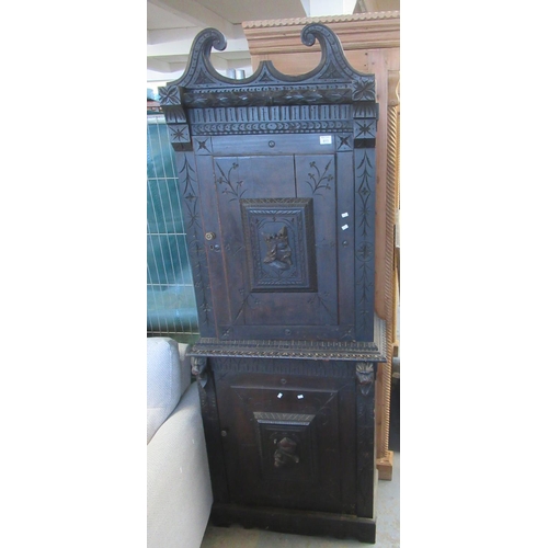 613 - 19th Century stained oak two stage blind panelled cupboard with relief portrait panels, under a brok... 