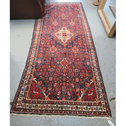 615 - Full pile blue ground Persian Surok runner with multi-coloured petal borders, 288 x 116cm approx. (B... 