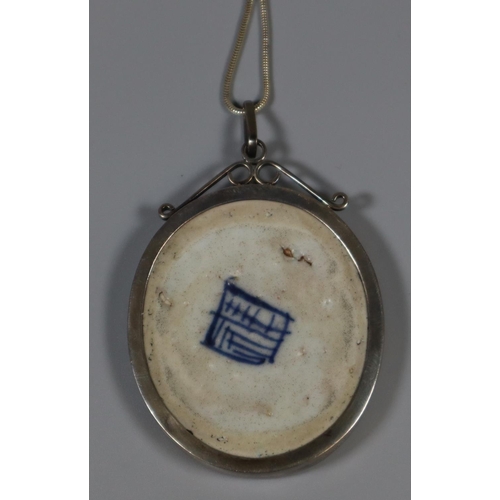 246 - Chinese blue and white porcelain shard set as an oval pendant within a silver pendant mount. Probabl... 