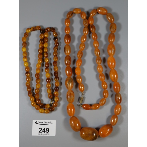 249 - Two strings of amber coloured resin beads.
 (B.P. 21% + VAT)