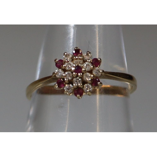 270 - 9ct gold flower head design ring, set with clear and red stones. 1.6g approx.
(B.P. 21% + VAT)