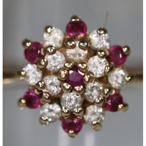 270 - 9ct gold flower head design ring, set with clear and red stones. 1.6g approx.
(B.P. 21% + VAT)