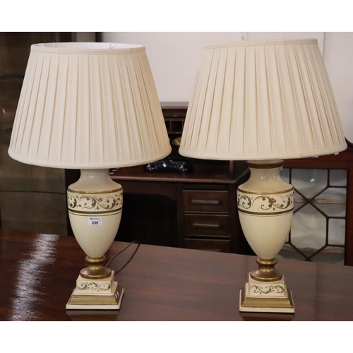 296 - Pair of modern cream ground urn shaped vases with shades, having gilt foliate decoration on square s... 