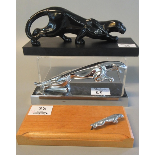 38 - Chrome plated Jaguar leaping cat paperweight figure, together with an oak paperweight with miniature... 