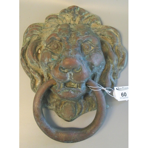60 - Heavy cast metal door knocker in the form of a lion mask with ring. 23 x 20cm approx. 
(B.P. 21% + V... 