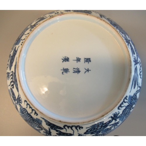 62 - Modern Chinese porcelain blue and white bowl with flat everted rim, overall decorated with dragons c... 