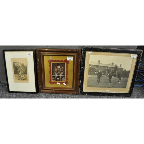 146 - Framed vintage photograph of an elderly gentleman sitting in a high back fireside chair cradling a d... 