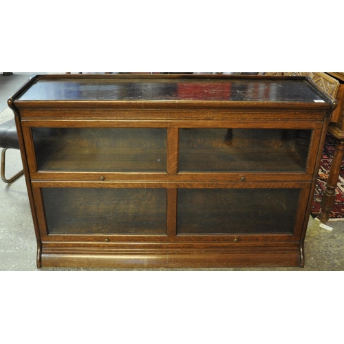 485 - Early 20th Century oak two sectional Wernicke type bookcase, the moulded top above four glass panels... 