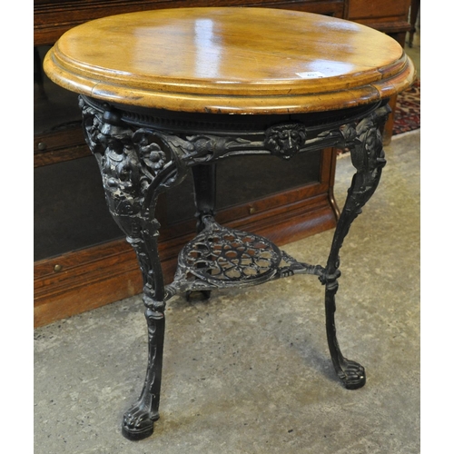 491 - Late Victorian cast iron pub table of circular form, the base decorated with lion masks, flowers and... 