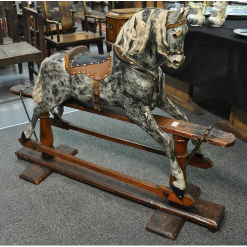 508 - Early 20th Century dapple grey child's rocking horse on patent swing stand, with leather saddle and ... 