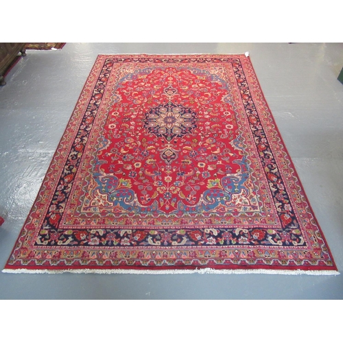 512 - Middle Eastern design Mashad carpet on a mainly red ground with multi-coloured stylised floral and f... 