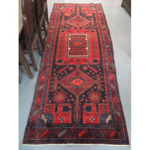 522 - Middle Eastern design Brojerd runner on a red and blue ground with central medallions decorated with... 