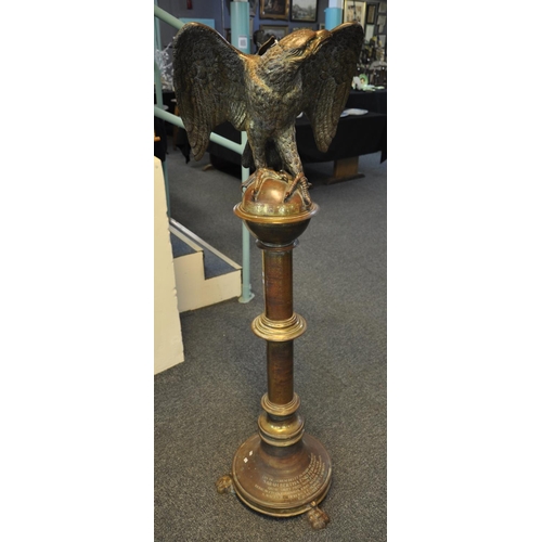 526 - Unusual heavy gilt brass memorial lectern, the pediment with a study of a perched eagle with outswep... 