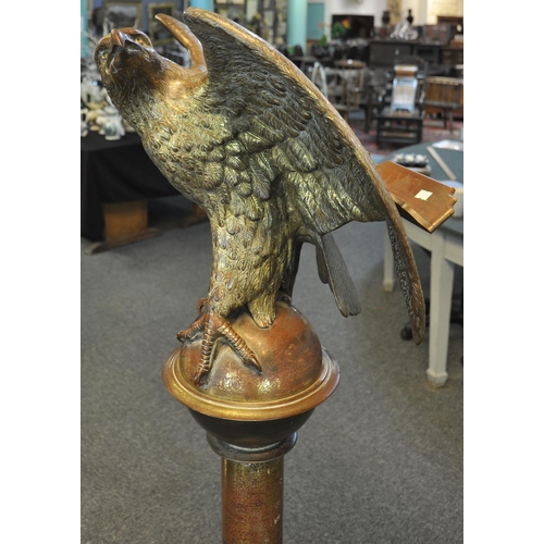 526 - Unusual heavy gilt brass memorial lectern, the pediment with a study of a perched eagle with outswep... 